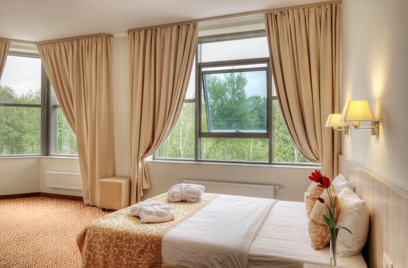 Bright and comfortable Premium hotel room with natural lighting at Golden Key Hotel.