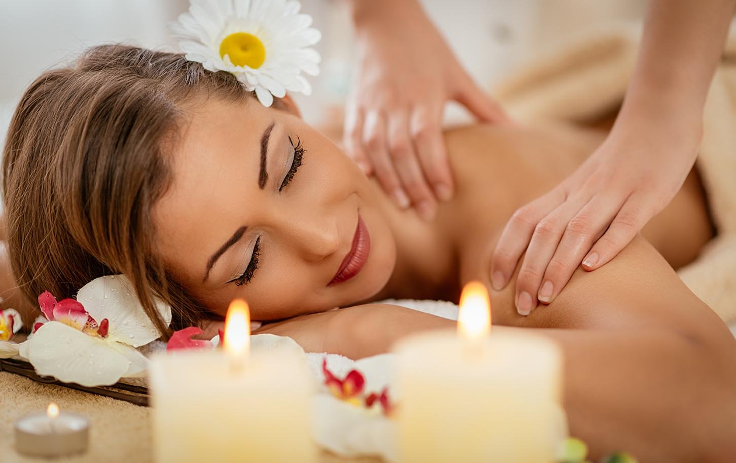 Guest enjoying a relaxing hot stone massage at Golden Key Hotel spa.