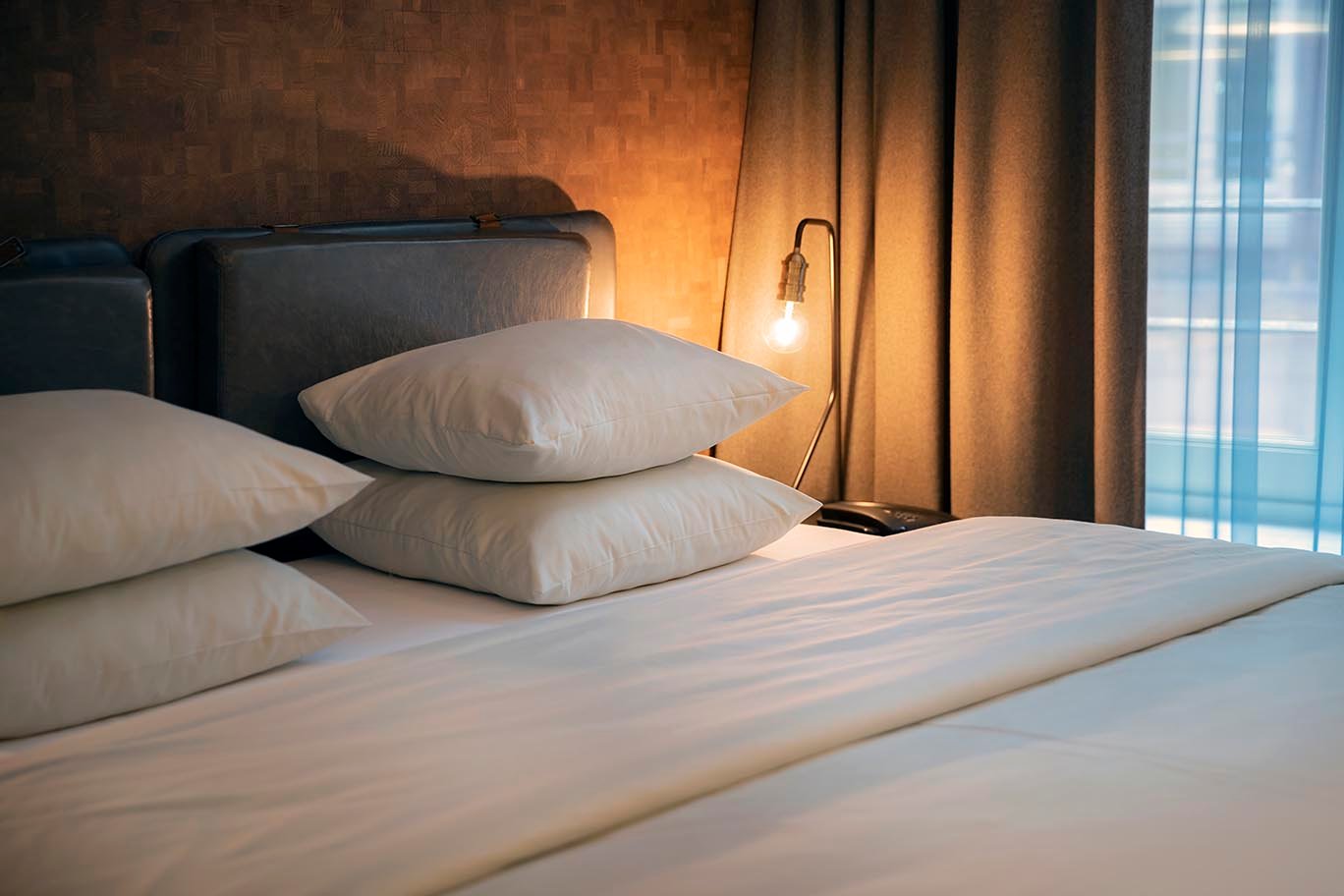 Super Deluxe luxury hotel room with a plush bed and warm lighting at Golden Key Hotel.